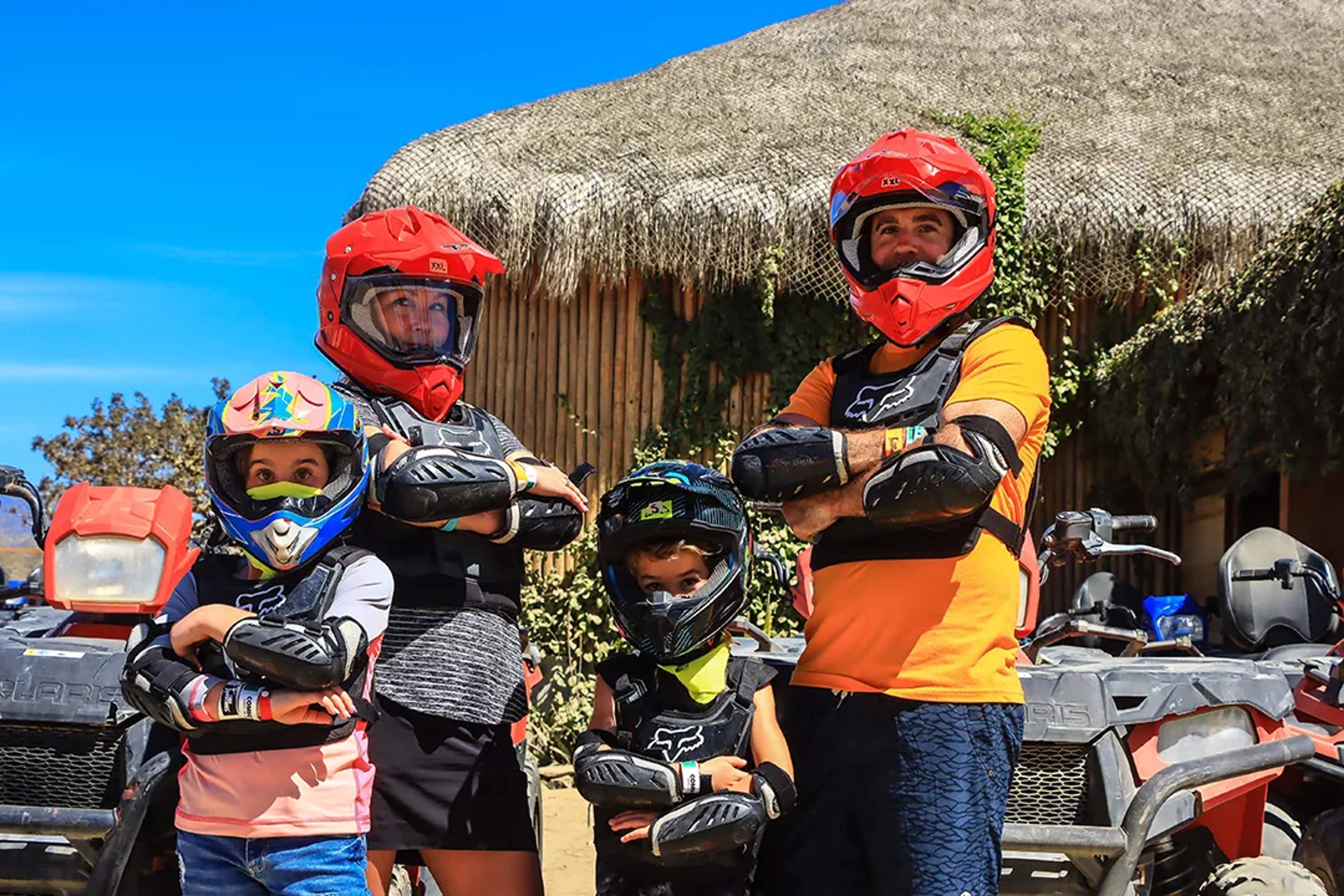 Family in protective gear ready for an ATV adventure under the sun.