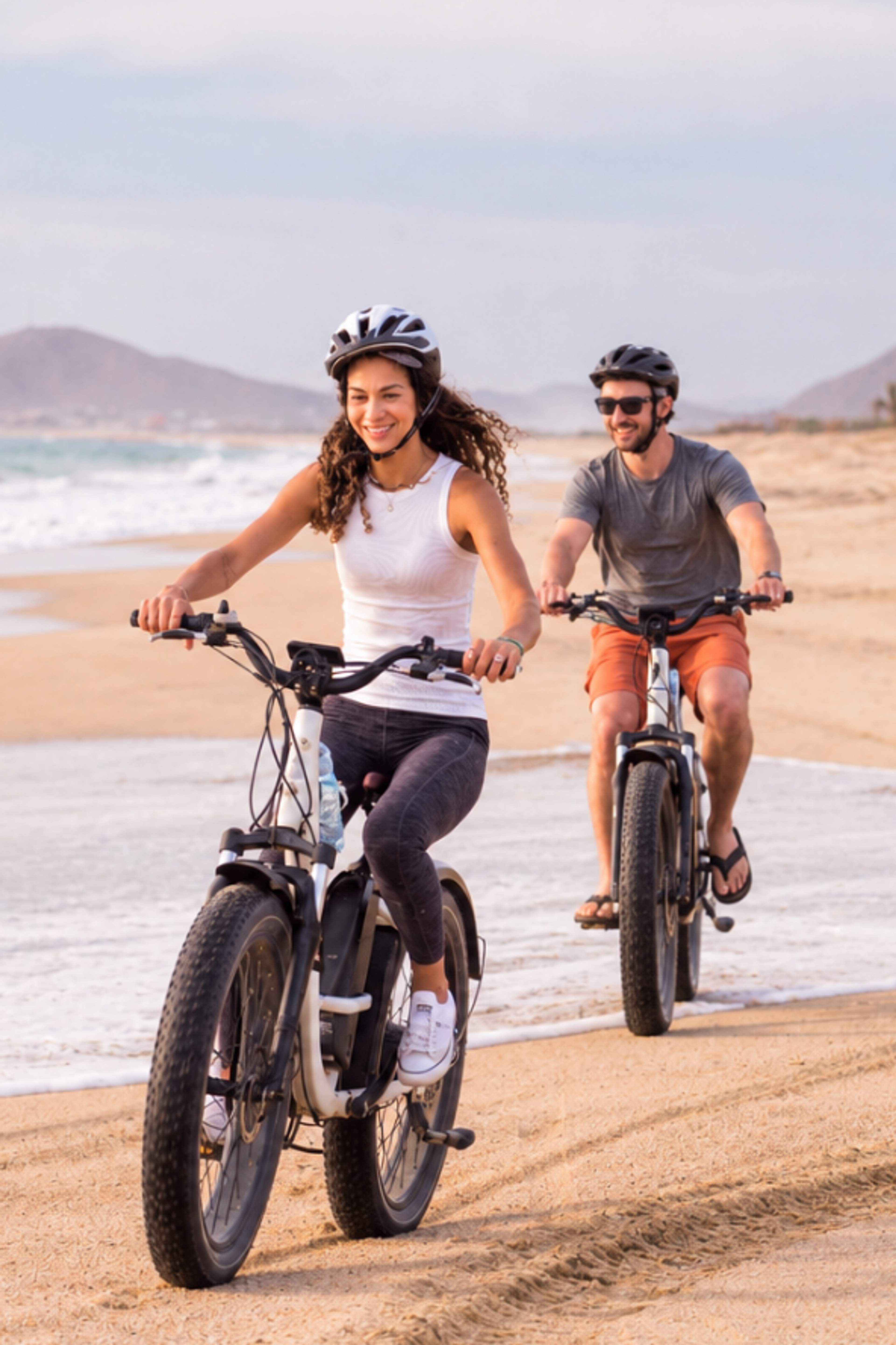 Couple riding along the beach on the Cabo Adventures E-Bike Adventure tour in Cabo.