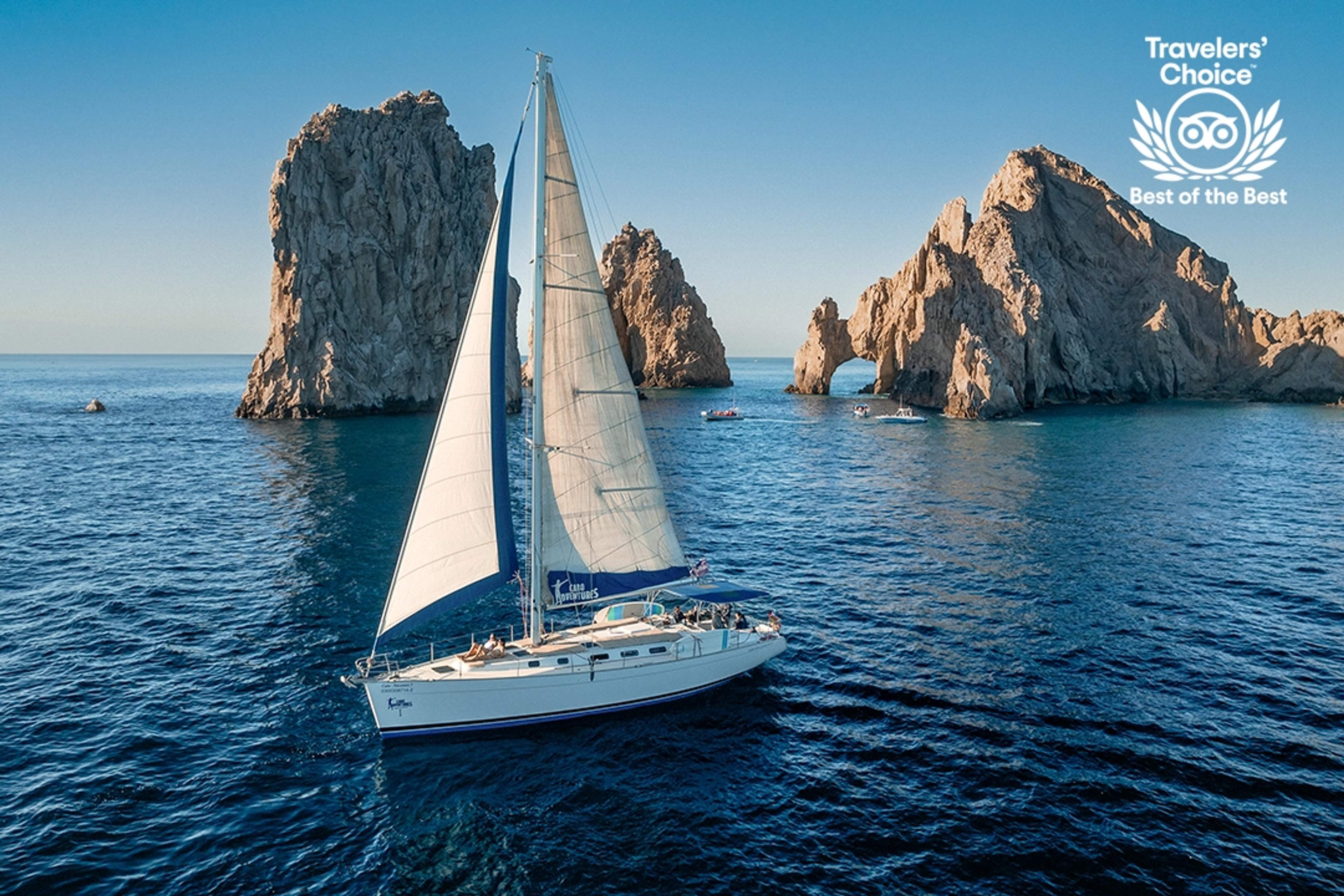 Un velero navegando en aguas tranquilas bajo un cielo azul claro, con un distintivo "Best of the Best".