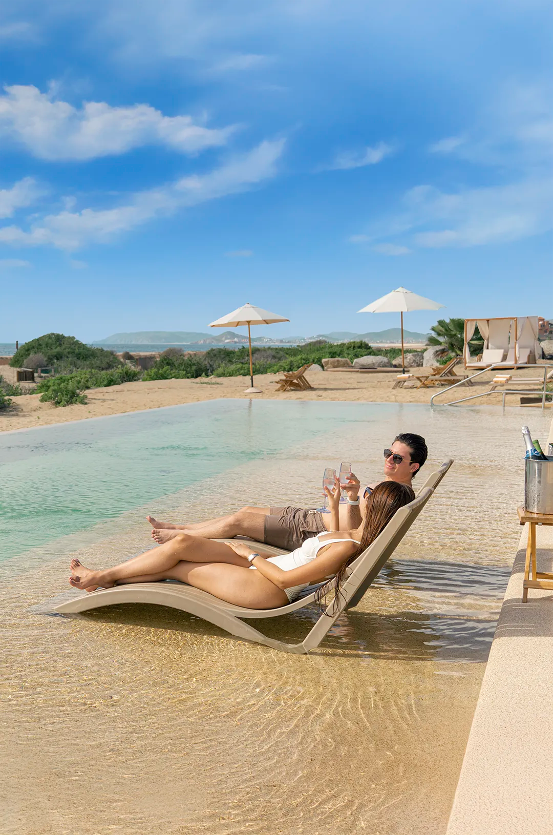 Couple enjoying the pool at Tierra Sagrada Beach Club