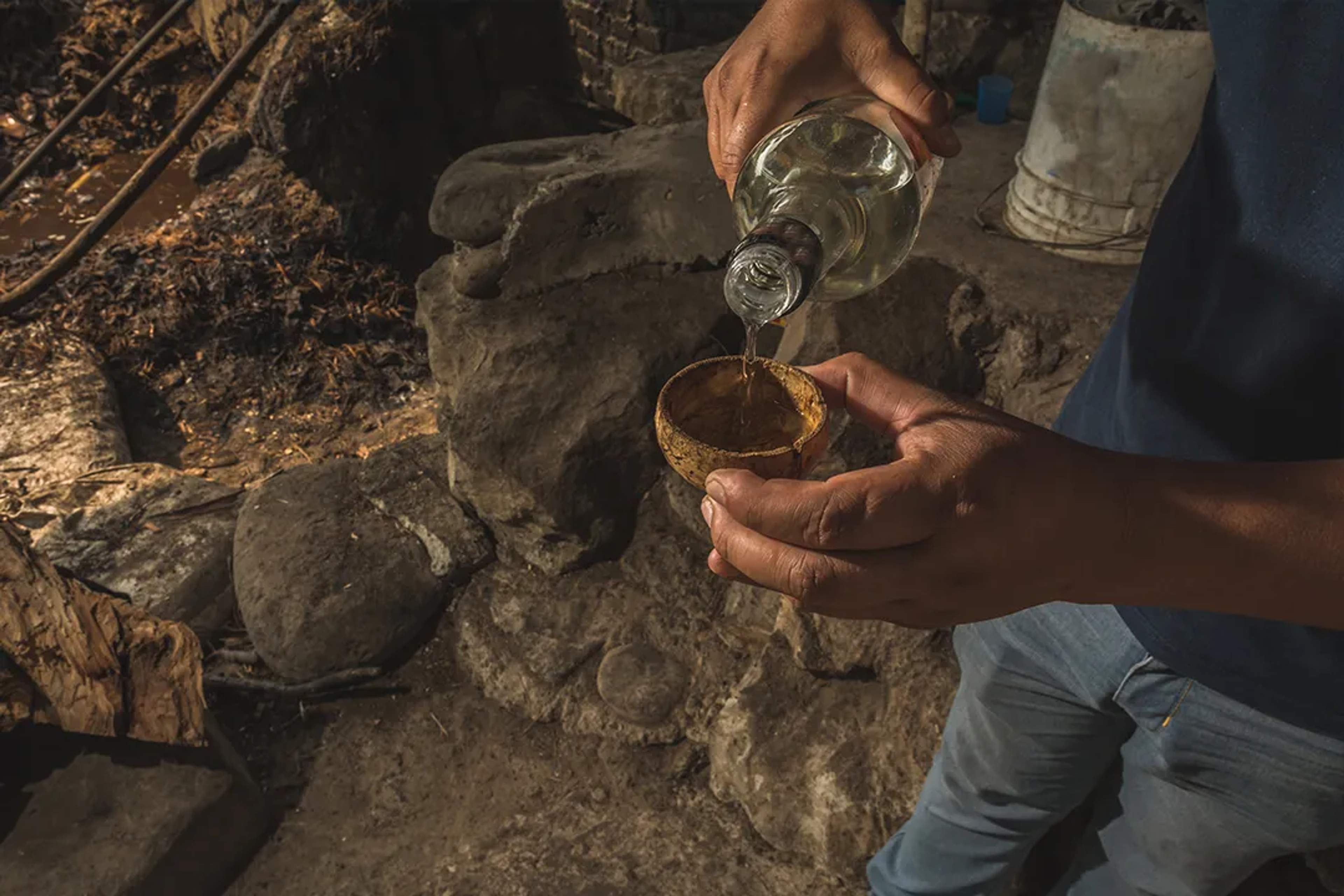 Rustic mezcal tasting during a traditional agave tour in Mexico, showcasing authentic local craft