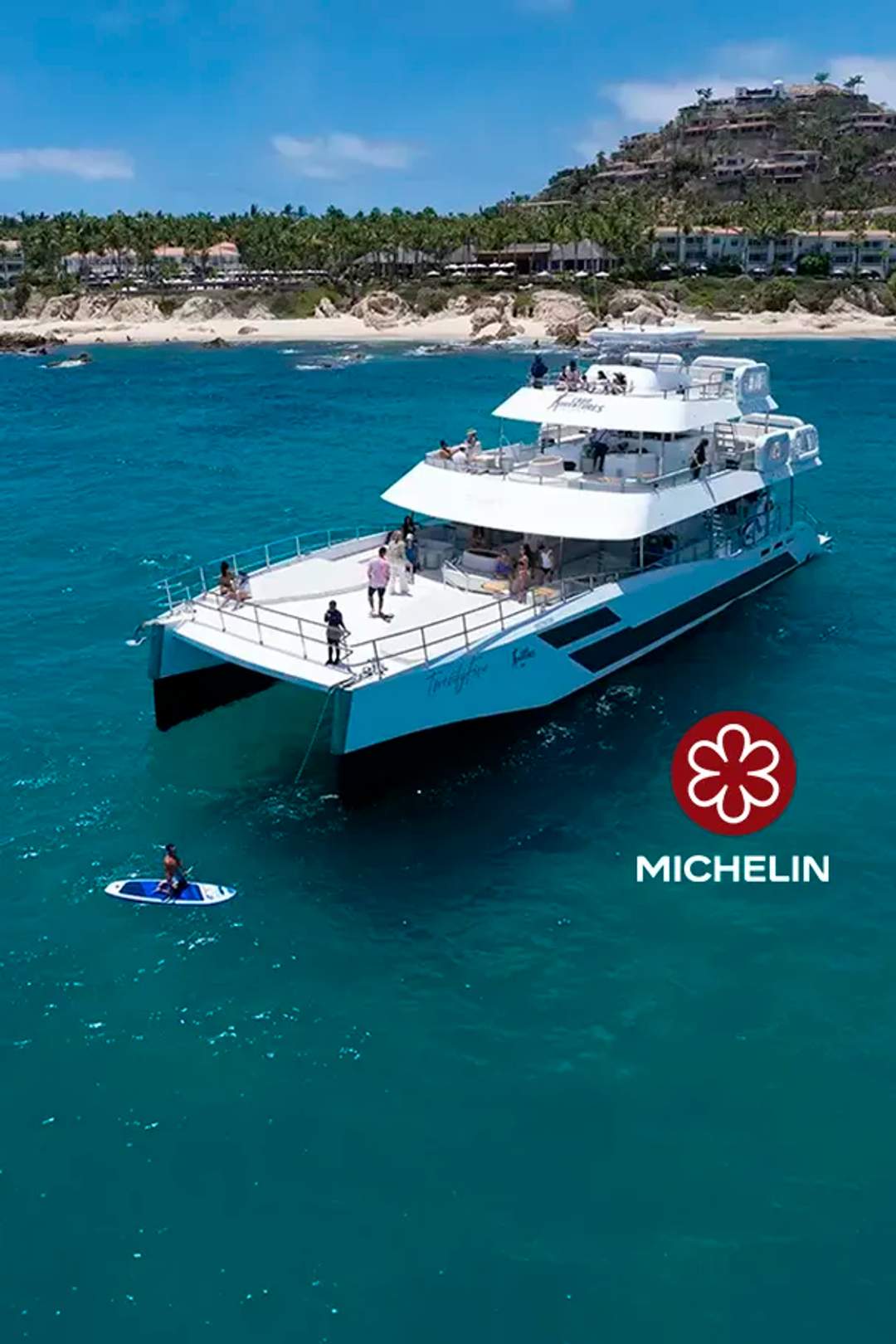TwentyFive premium 100-ft catamaran sailing in Cabo San Lucas, triple-deck design, open sea views and luxury day cruise.