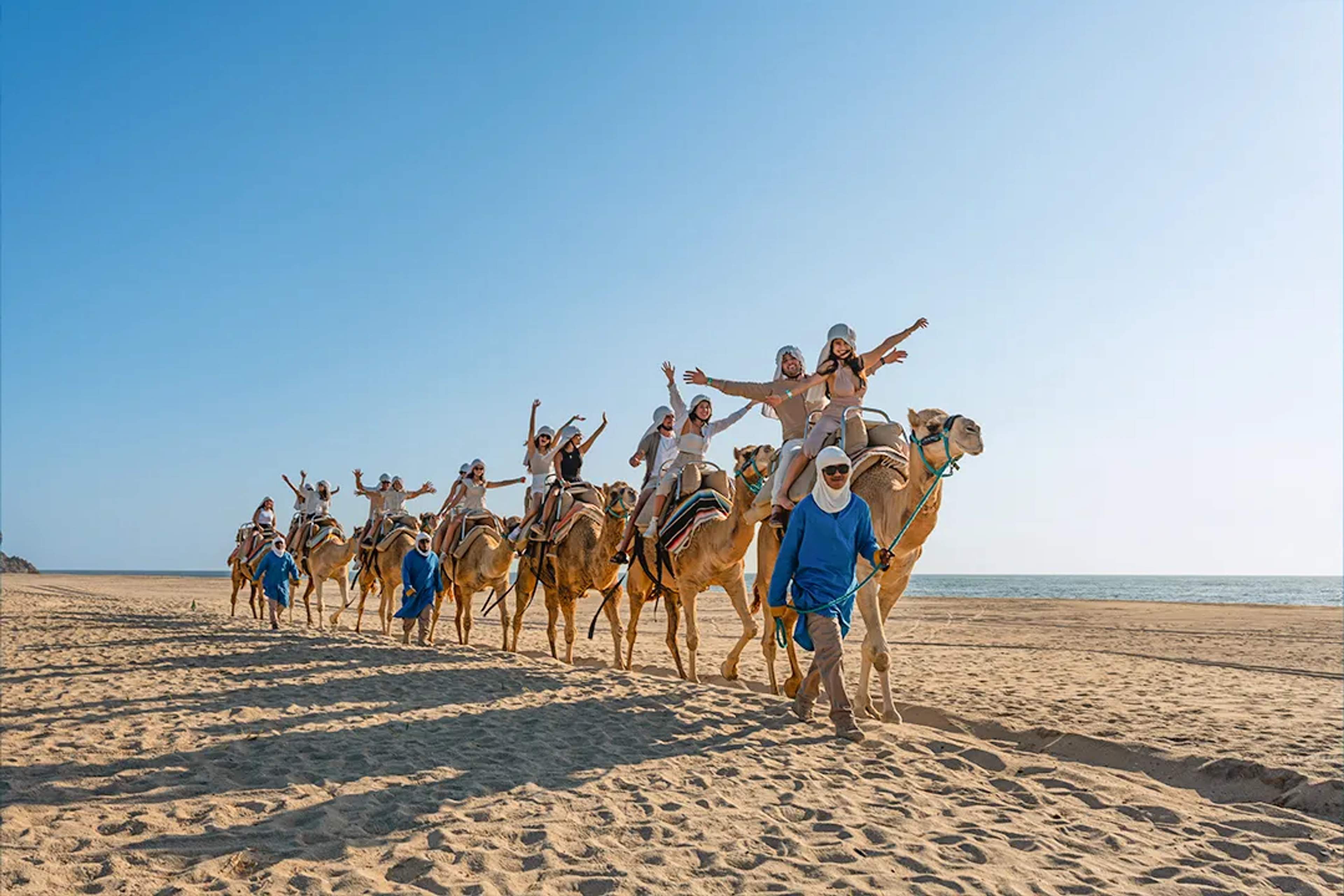 Camel ride adventure along a pristine beach in Los Cabos with ocean views and expert guides leading the tour