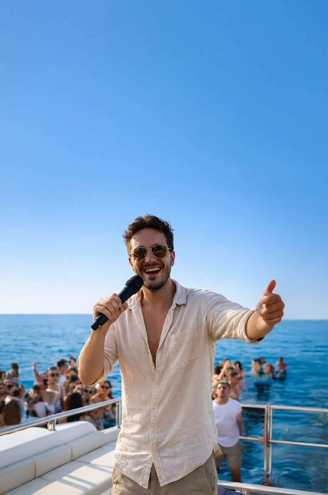 Host entertaining guests aboard the TwentyFive premium catamaran during a lively luxury day cruise in Cabo San Lucas.