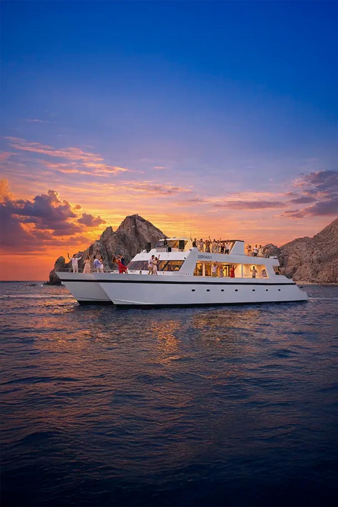 Sunset party cruise in Cabo San Lucas aboard Oceanus with Arch views, music, drinks, and dancing at sea