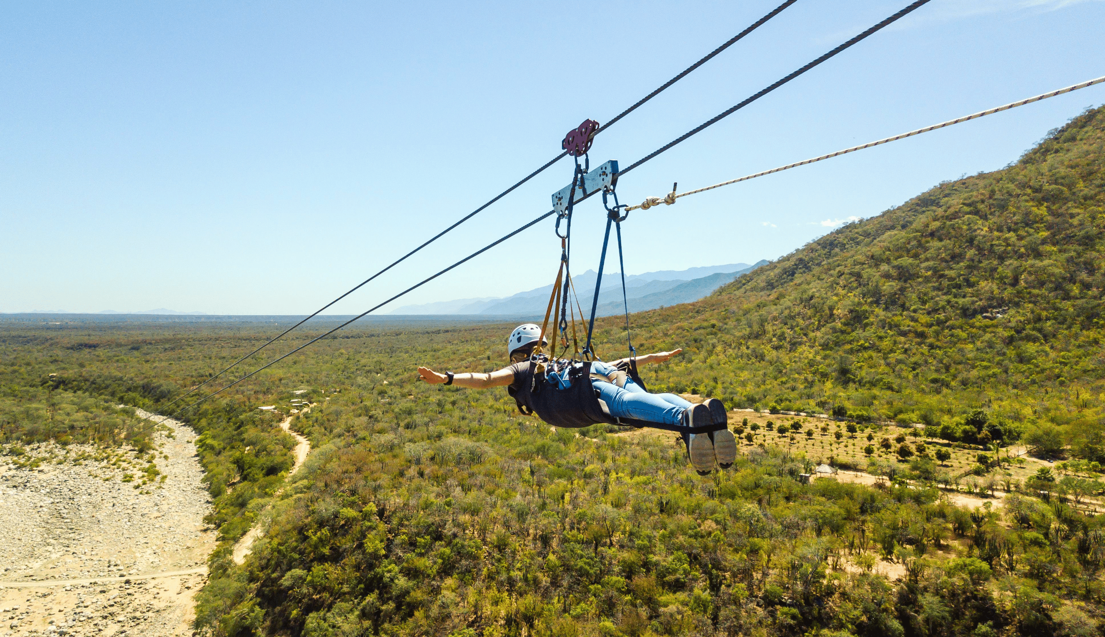 Young woman flying in the superman zip line 
