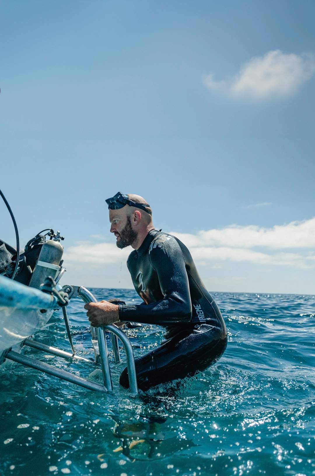 Diver climbing back onto the boat after a dive in Cabo Pulmo.