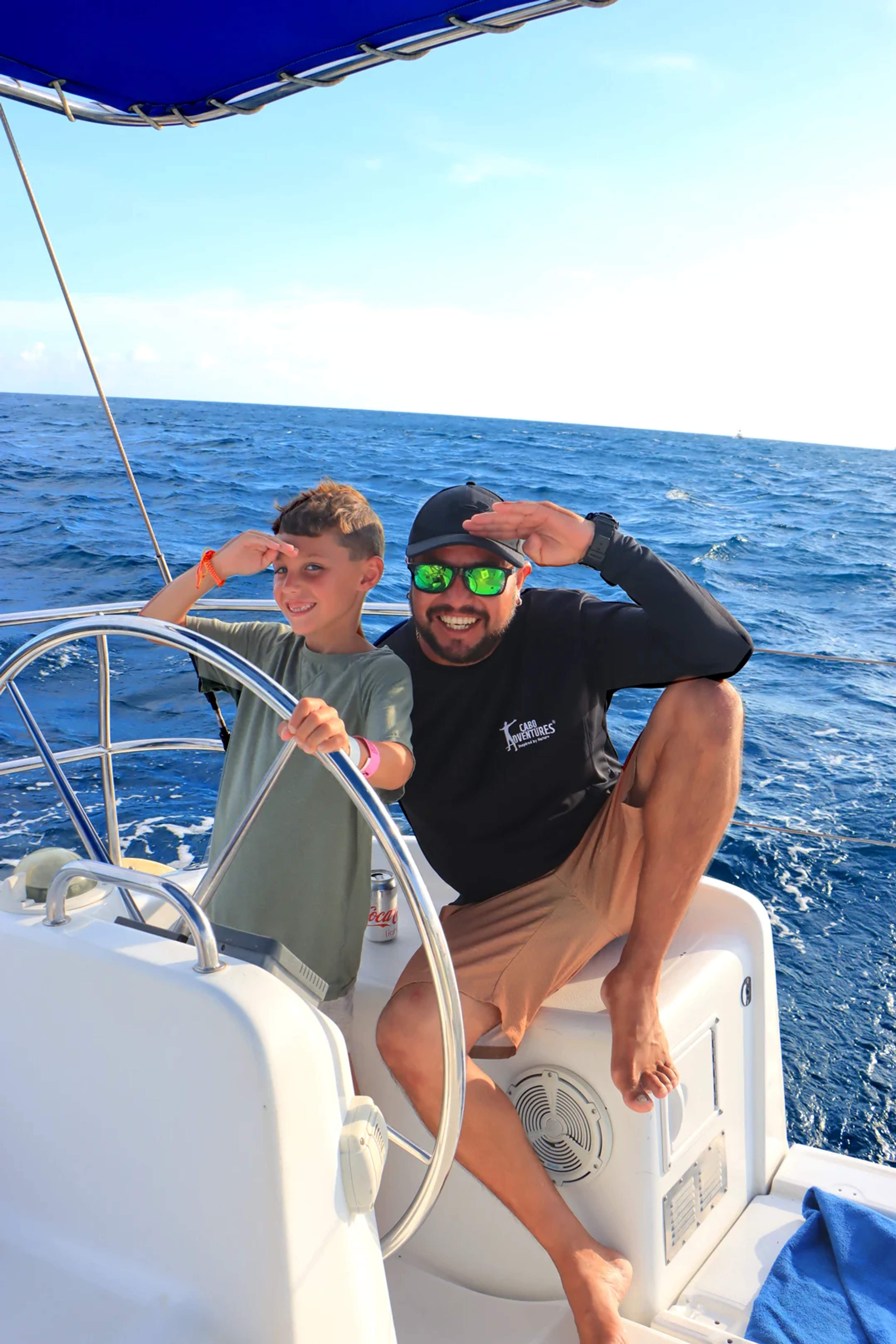 Crew member sailing with a kid client in a shiney day