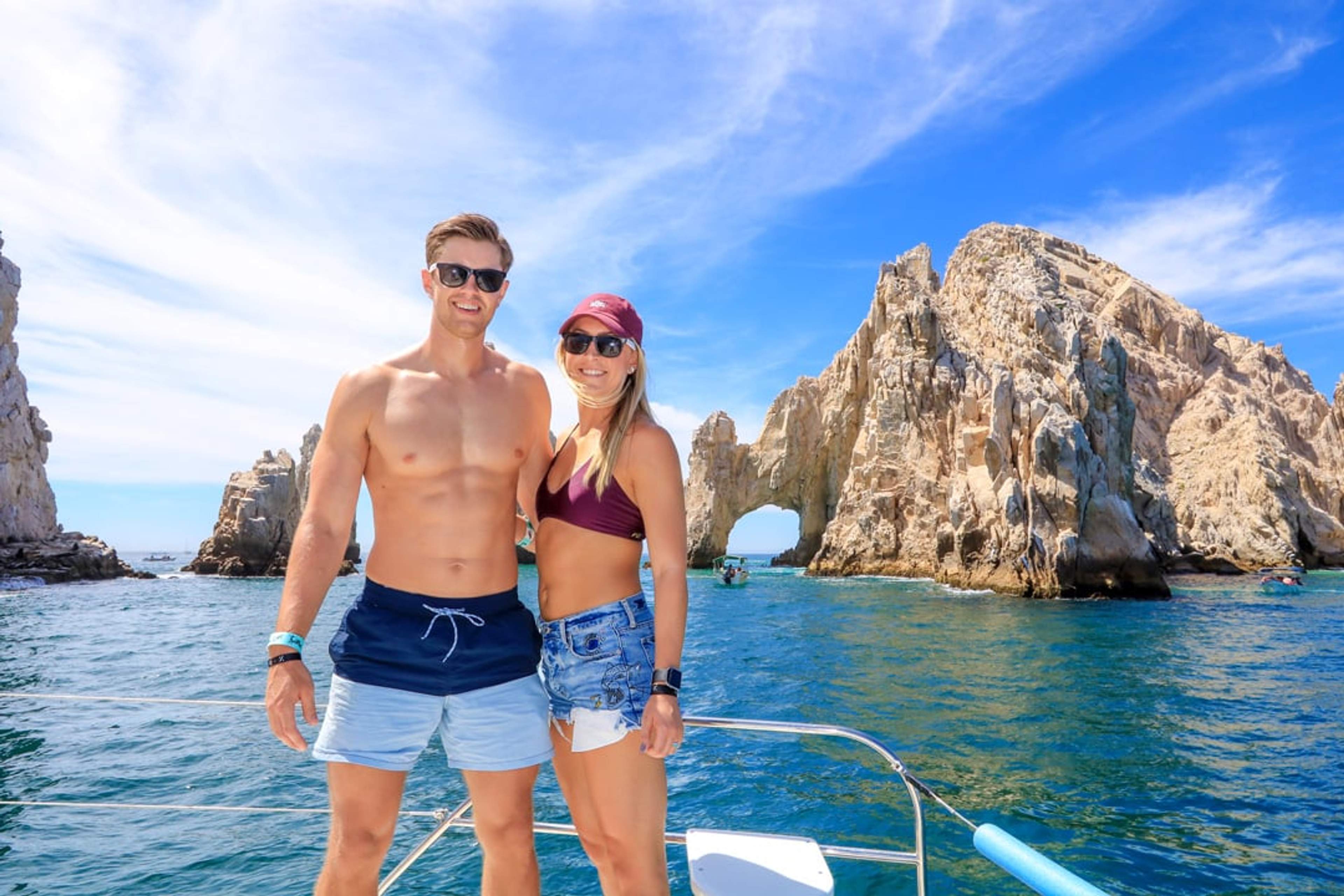 Handsome couple at the arch in Cabo