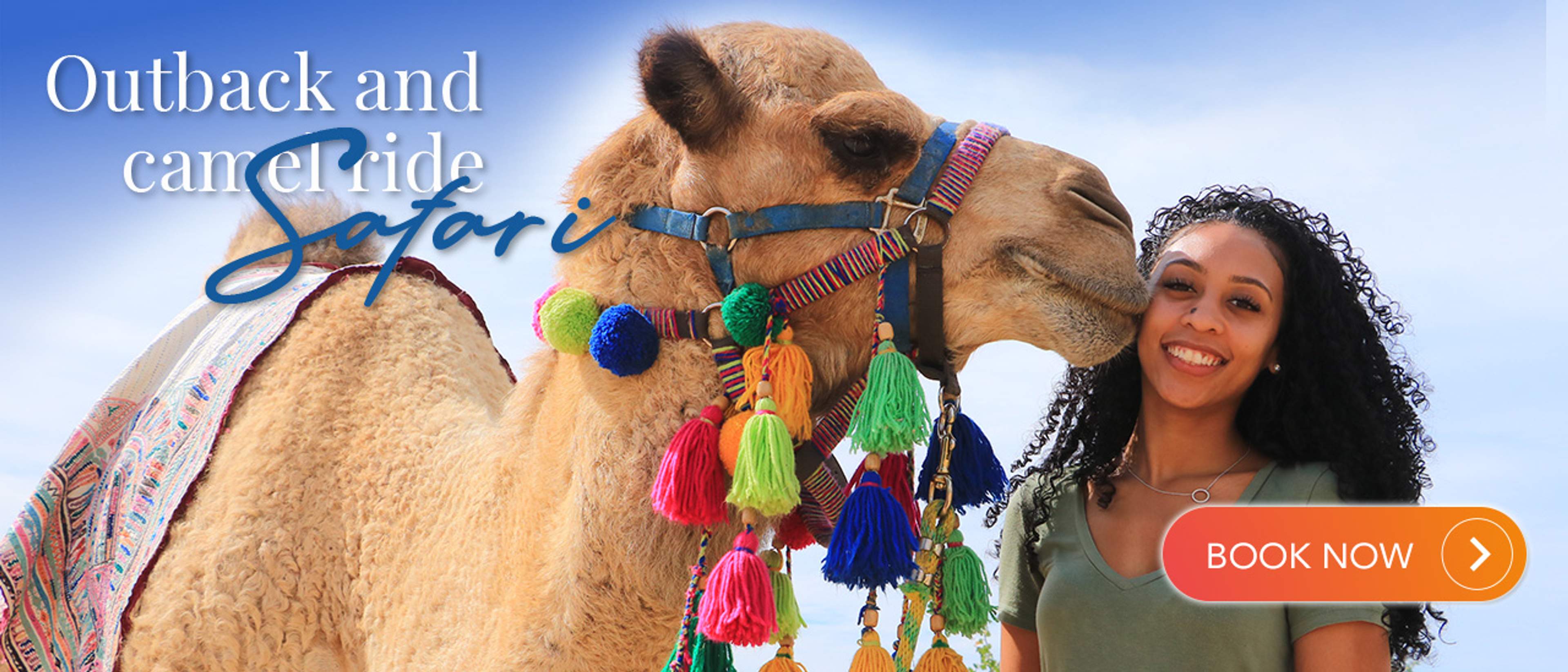 A smiling woman stands next to a camel adorned with colorful tassels and a decorative harness. The image features the text "Outback and camel ride Safari" at the top, with a "BOOK NOW" button in the bottom right corner, set against a bright blue sky background.