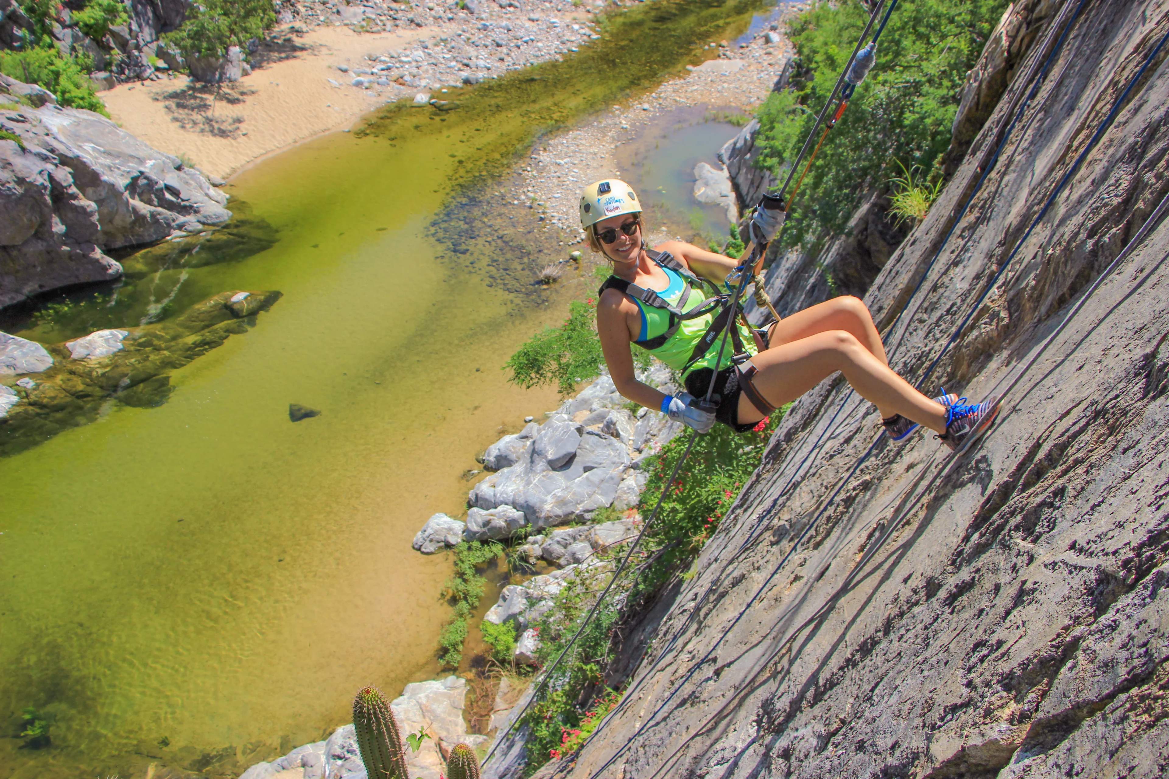 Rappeling down from a silde of a mountain