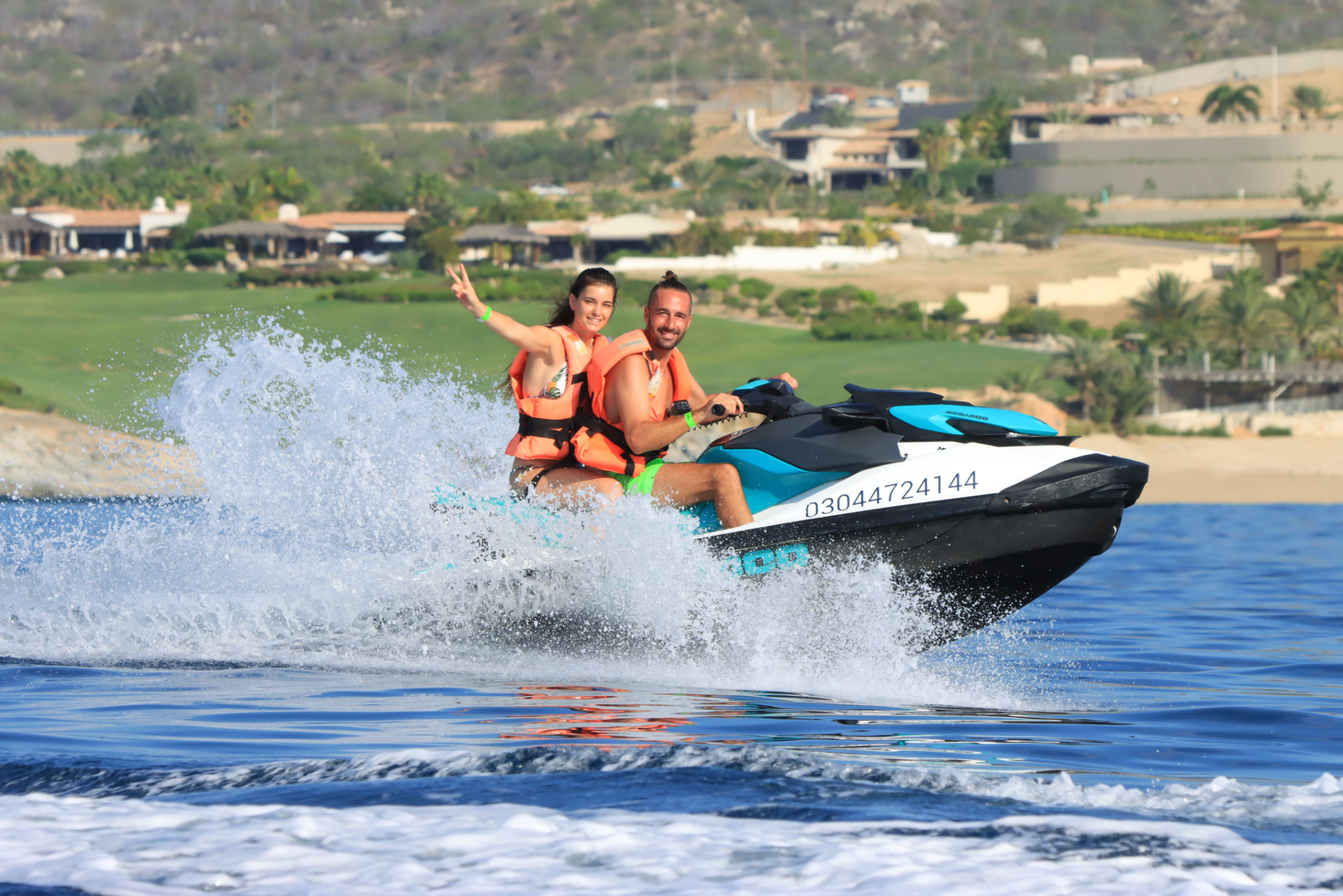 Couple on a ski boat all along the beach