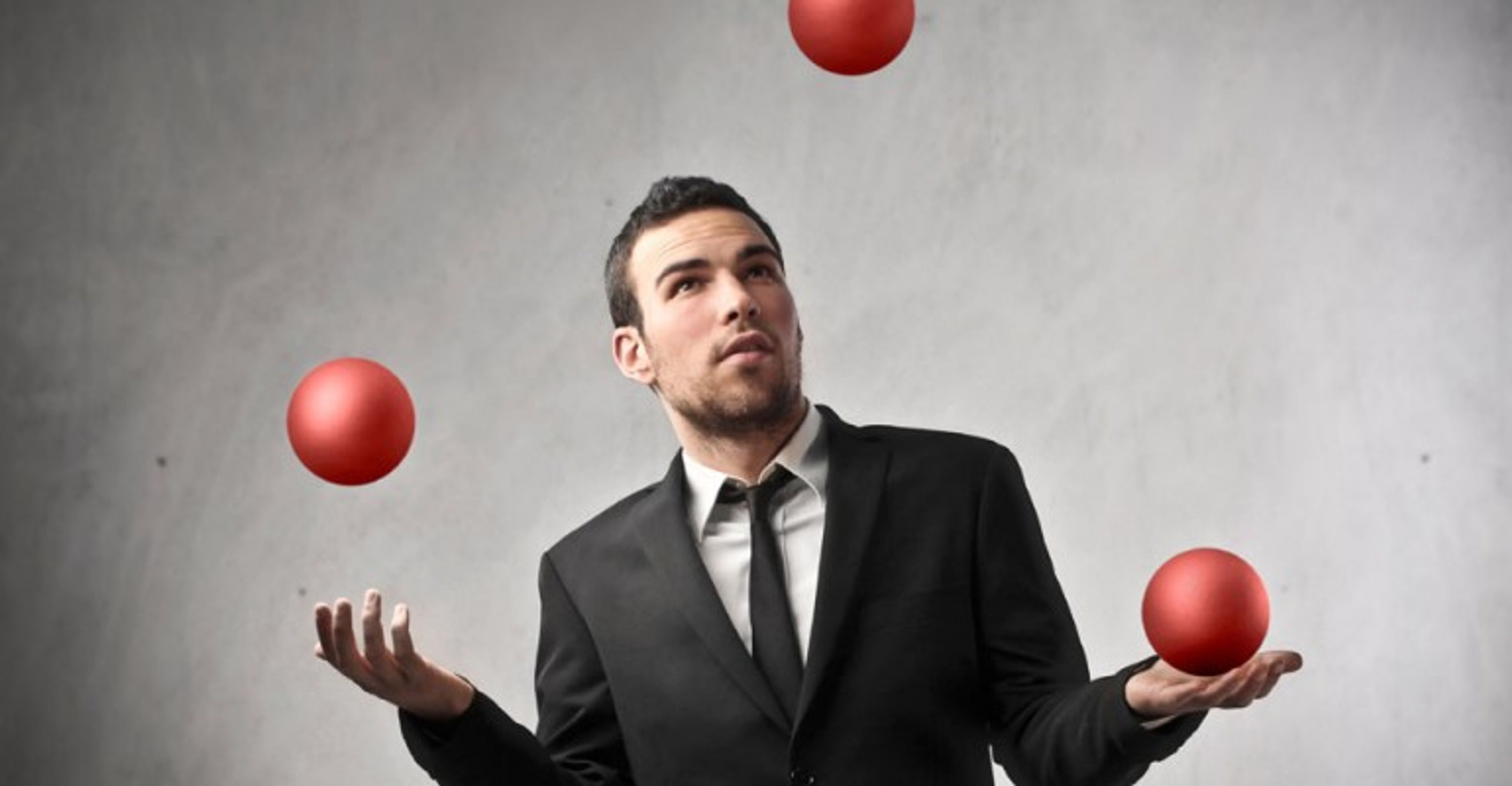 Man juggling with red balls