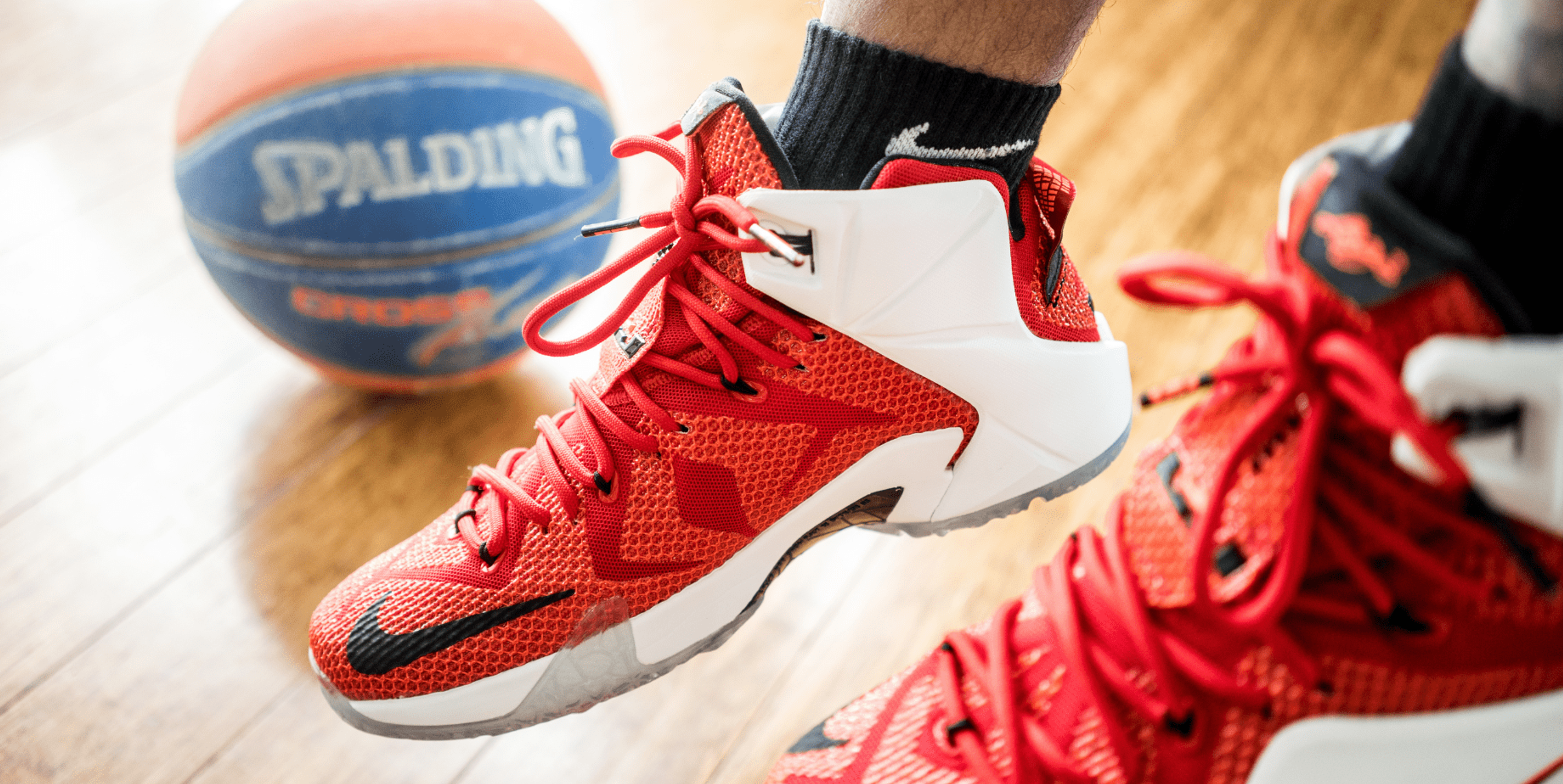 Red and white basketball shoes with basketball
