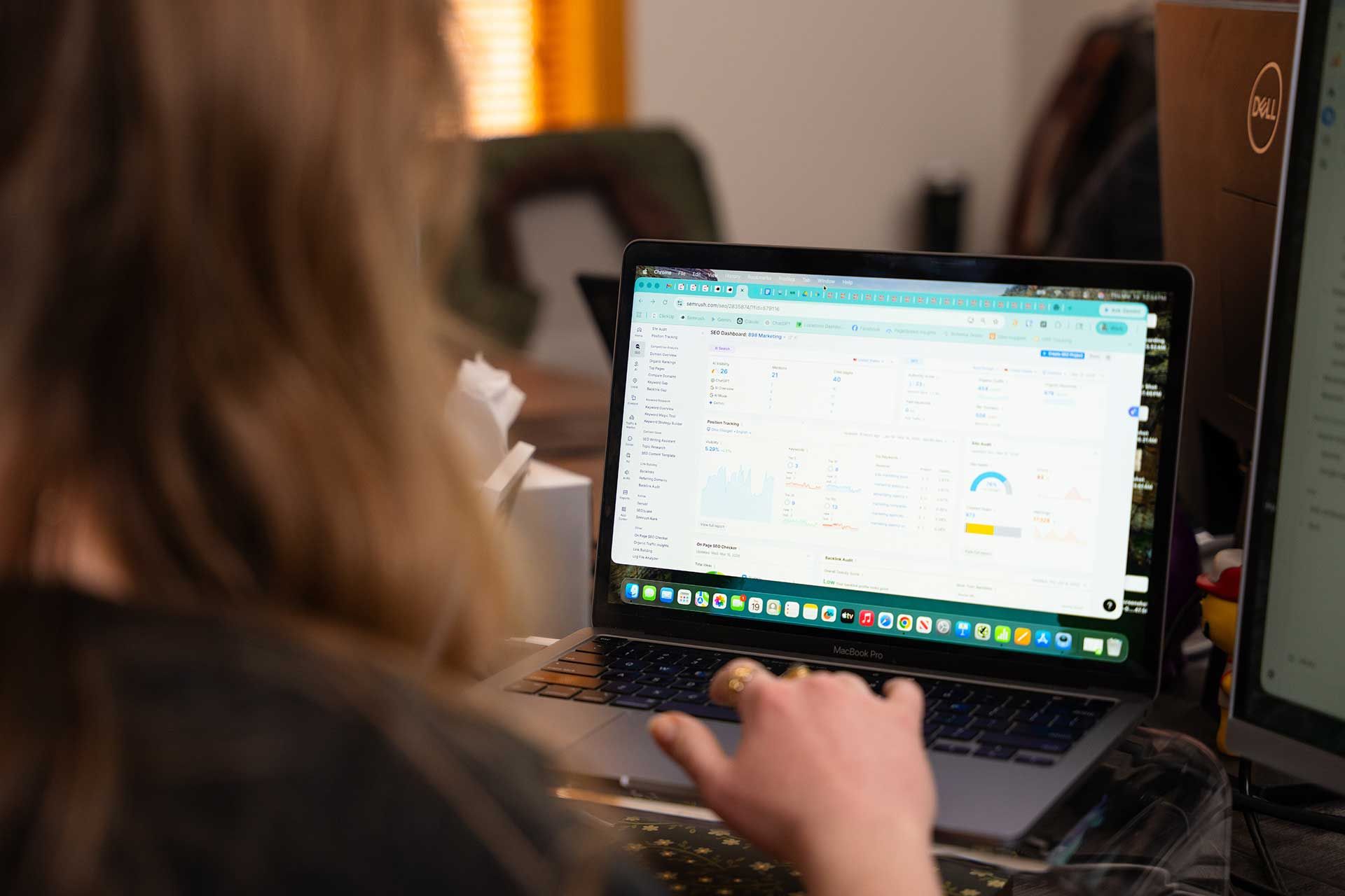 898 Marketing SEO specialist reviewing a Semrush dashboard for keyword and site performance