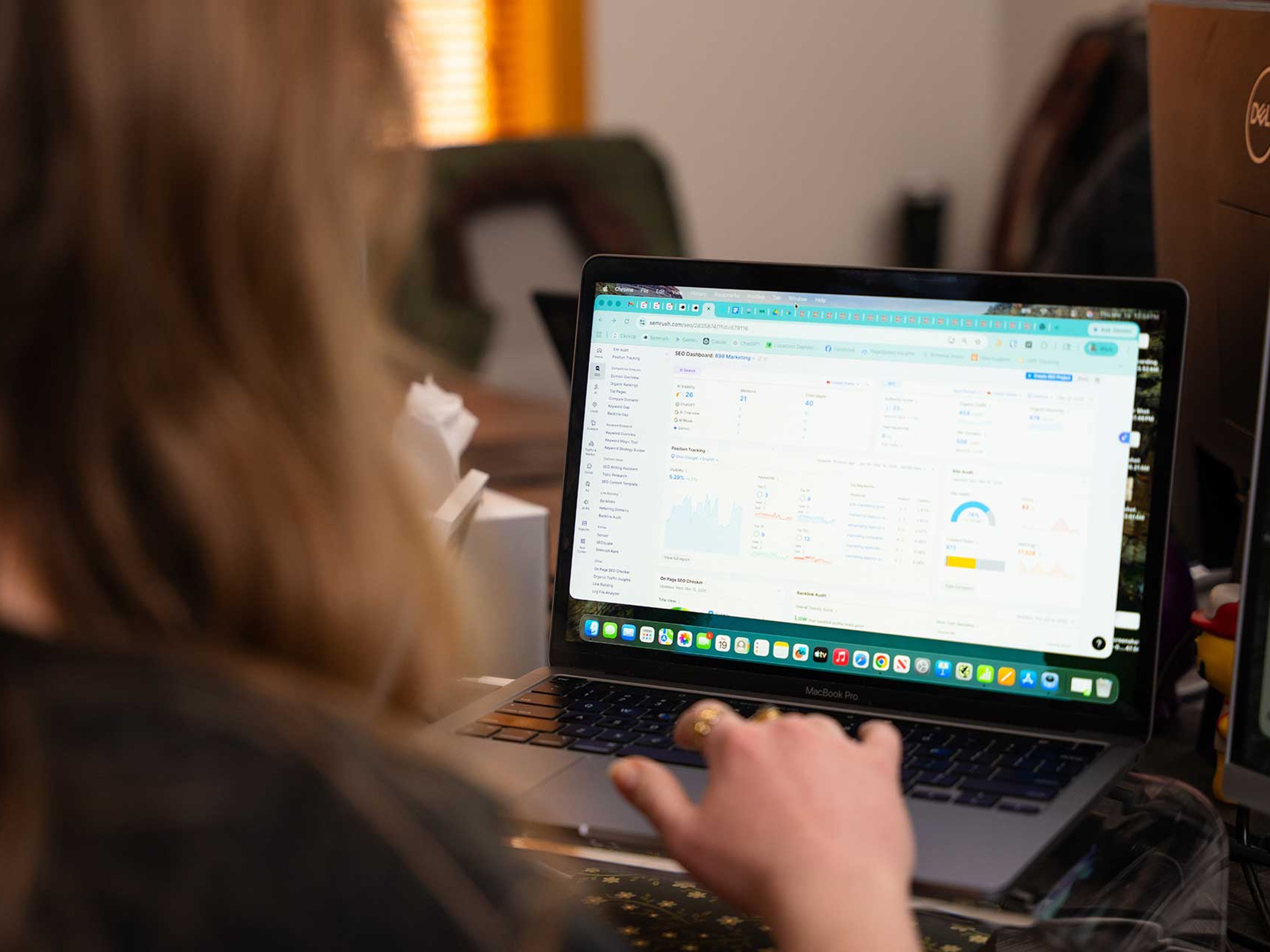 898 Marketing SEO specialist reviewing a Semrush dashboard for keyword and site performance