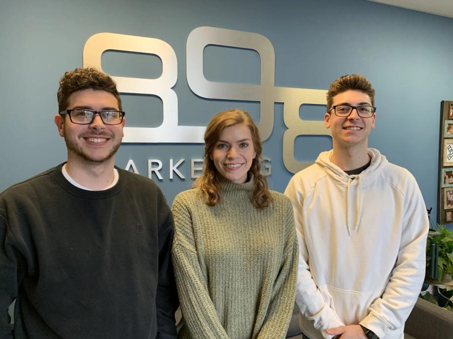marketing interns smiling in 898 marketing lobby