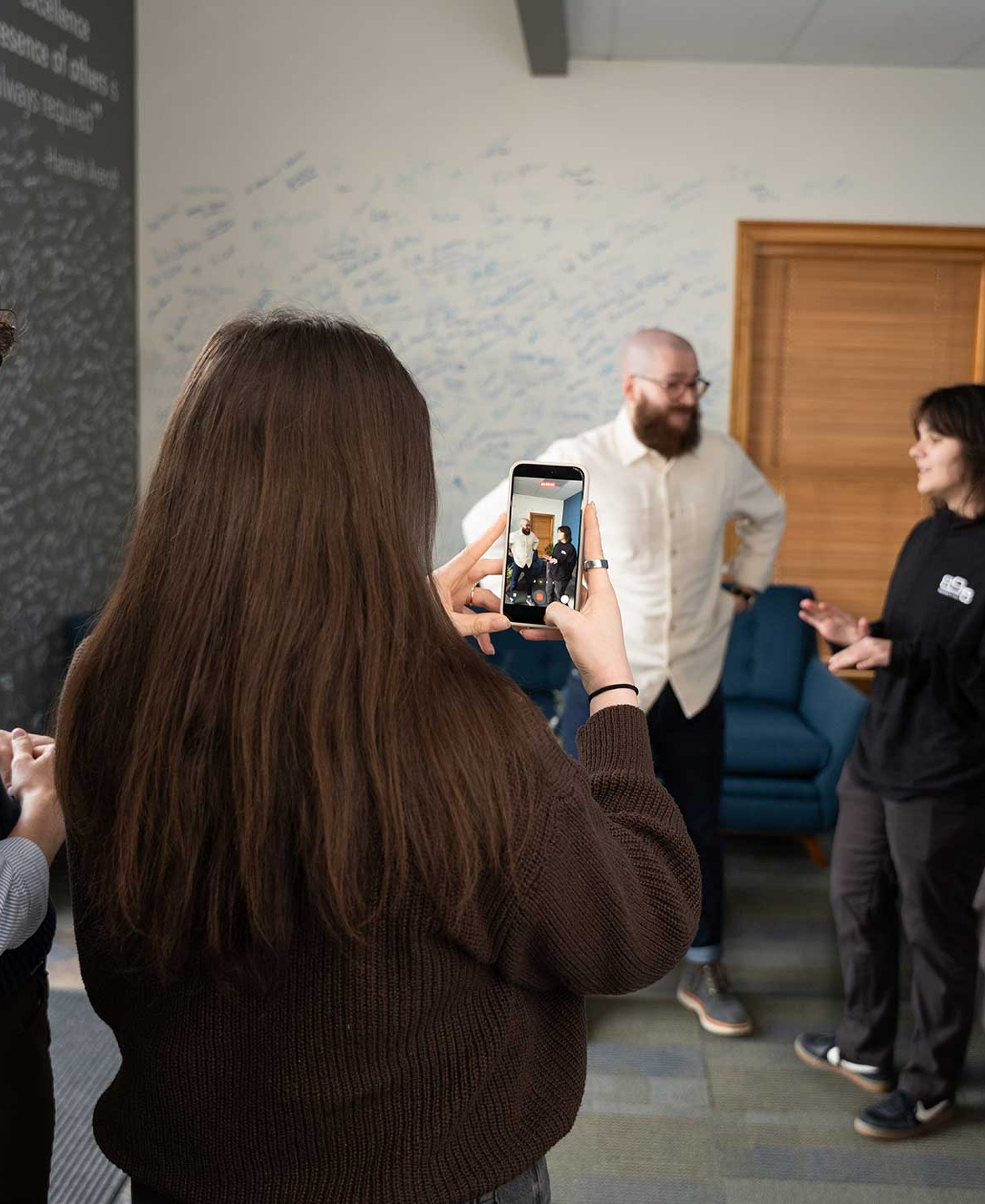 Two social media content creators filming a reel of two people talking.