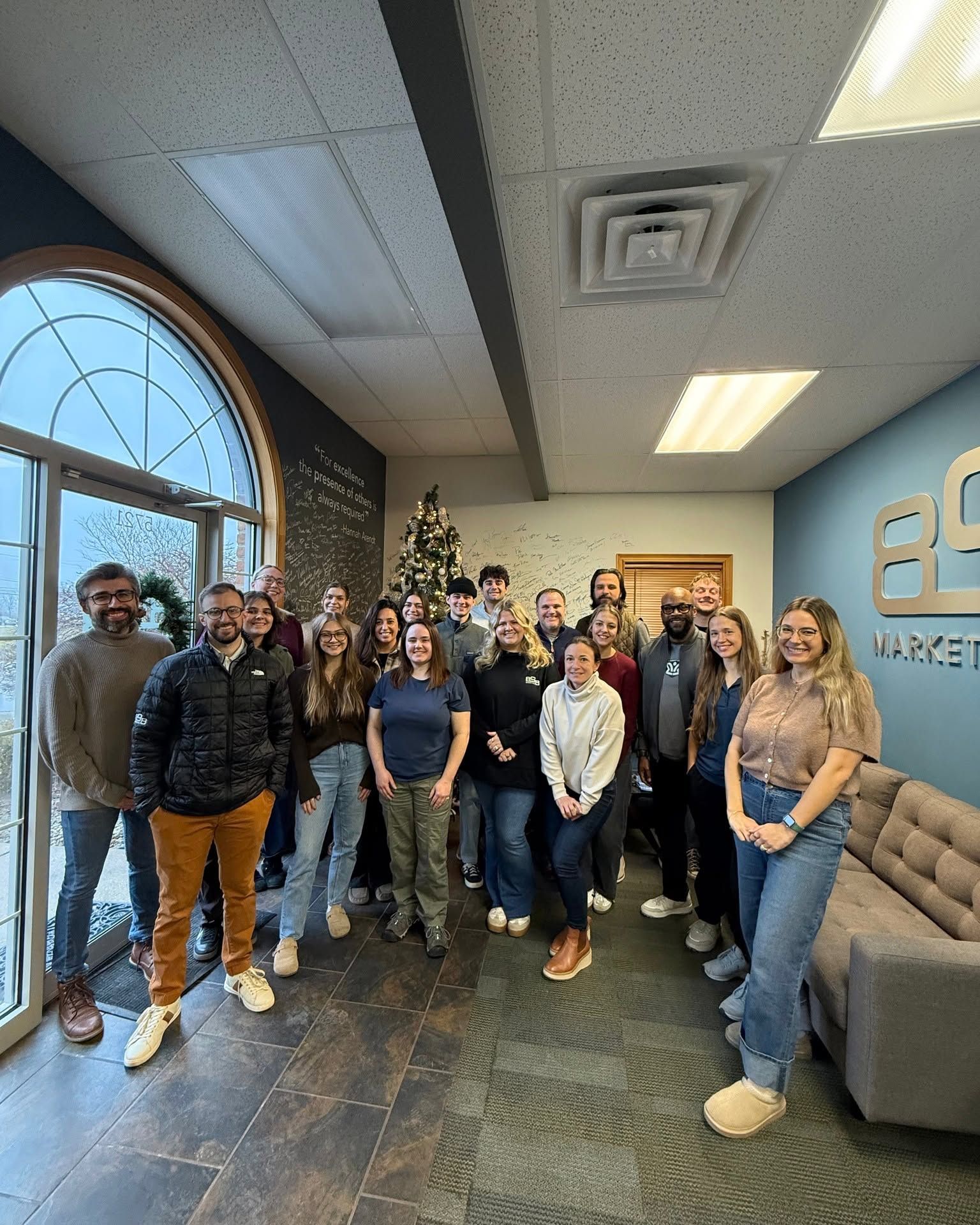 Photo of 898 employees standing in lobby of Canfield office