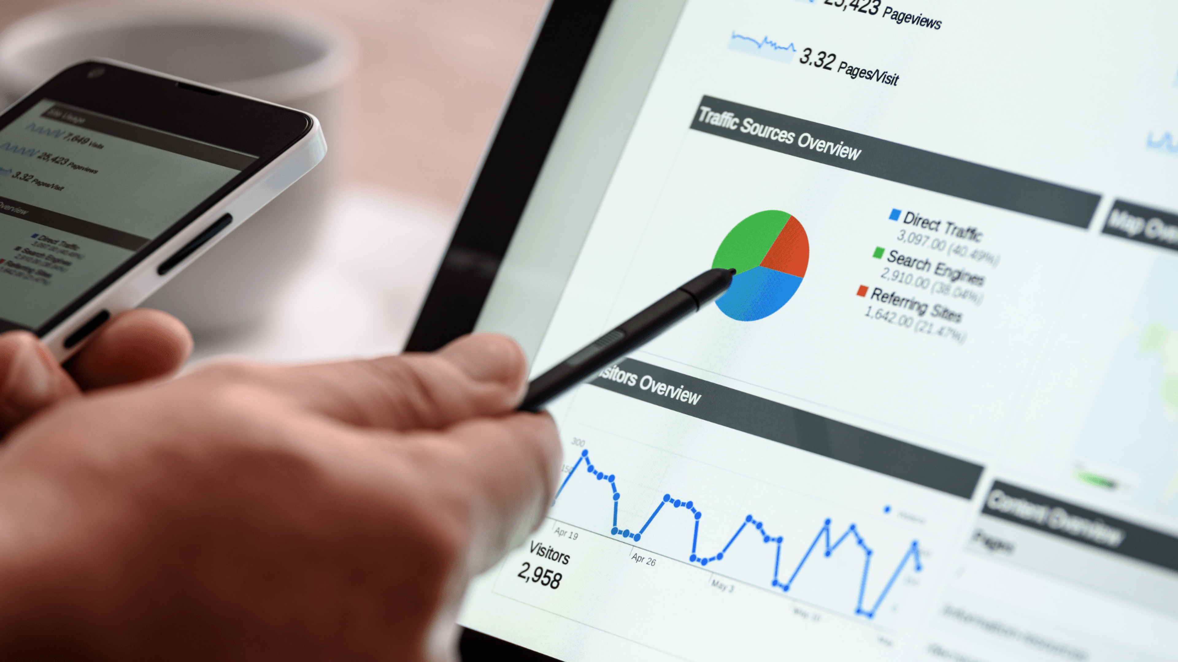 Man holding stylist pointing to pie chart on screen