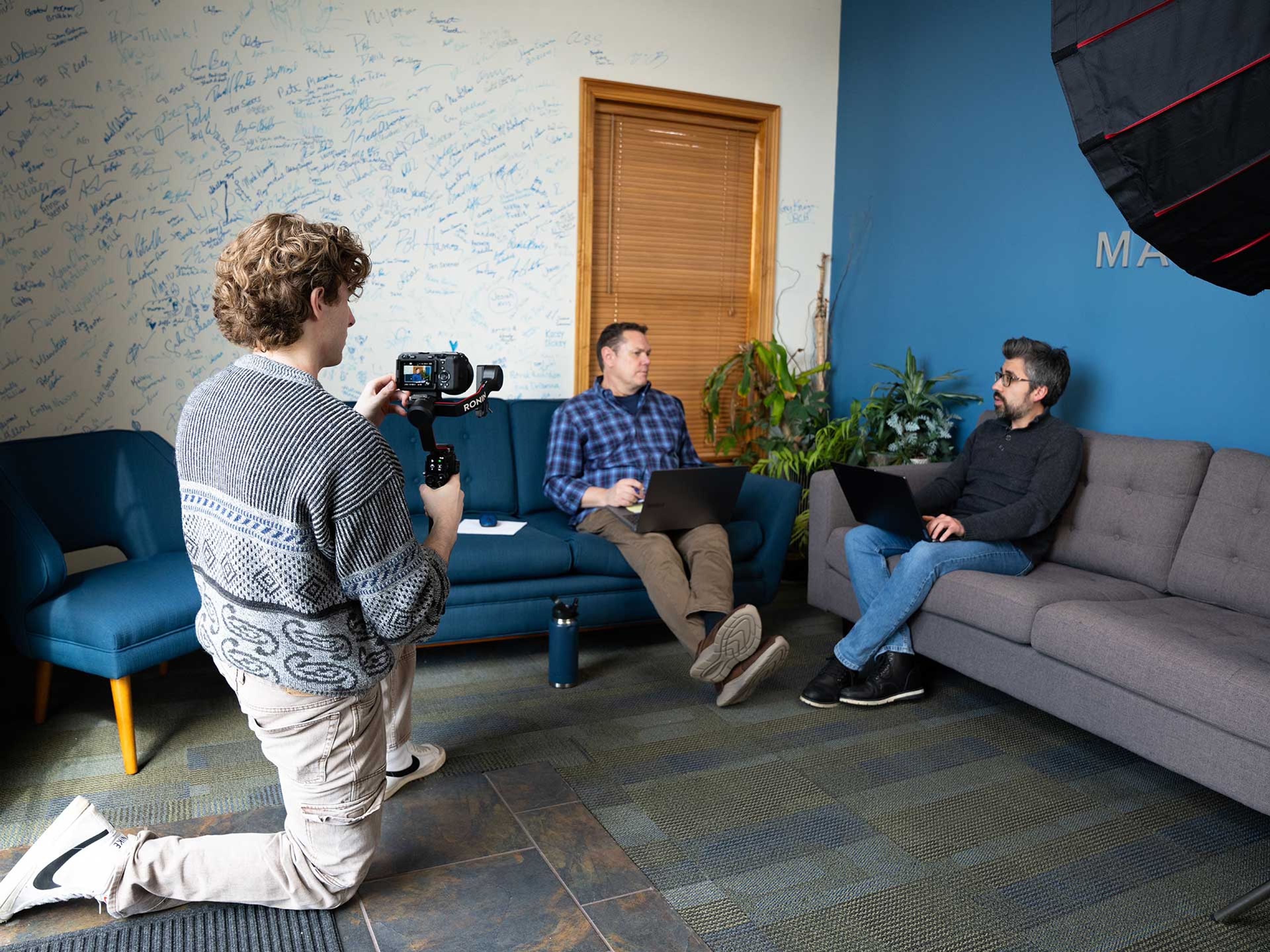898 Marketing videographer filming a client interview with a gimbal camera setup