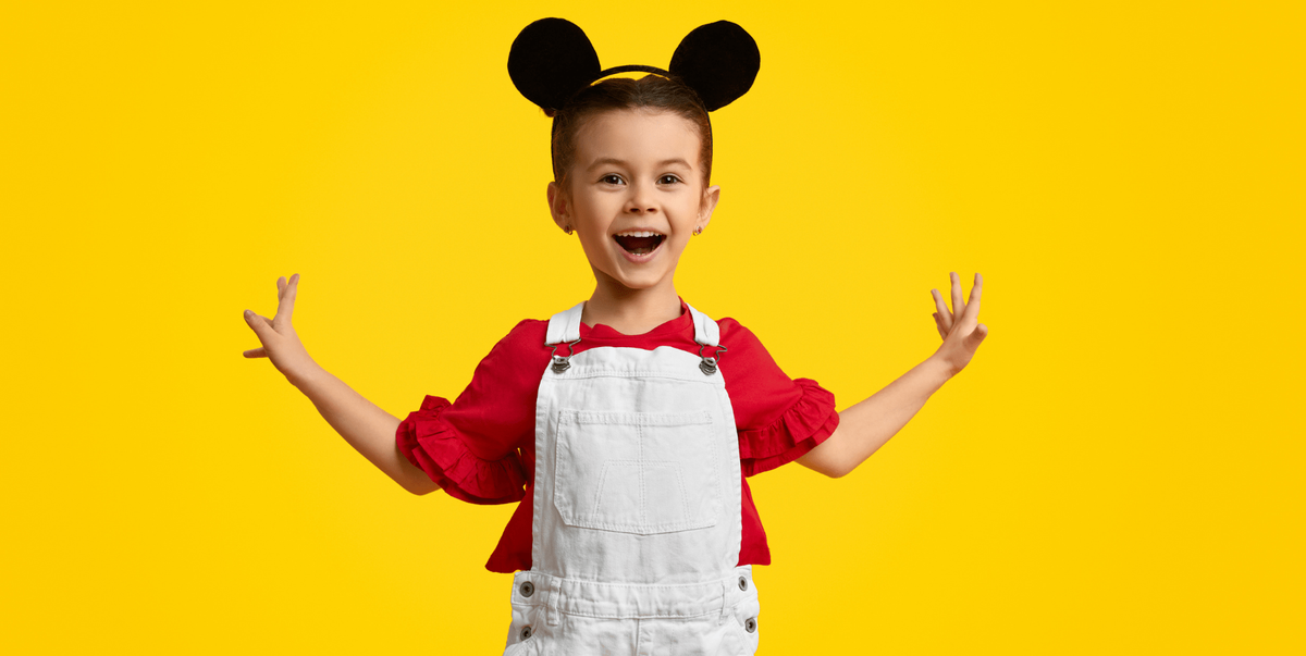 Little boy with overalls and mickey ears