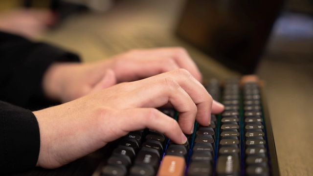 898 Marketing team member typing on a mechanical keyboard