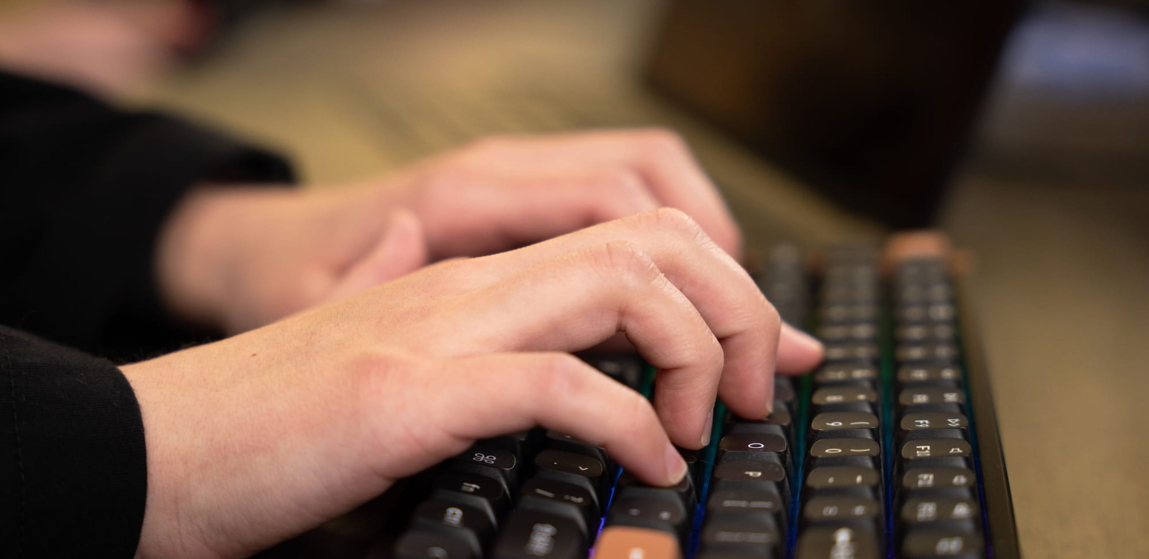 898 Marketing team member typing on a mechanical keyboard