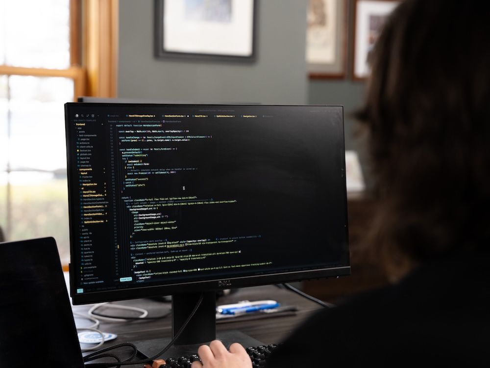 898 Marketing web developer writing code on a monitor