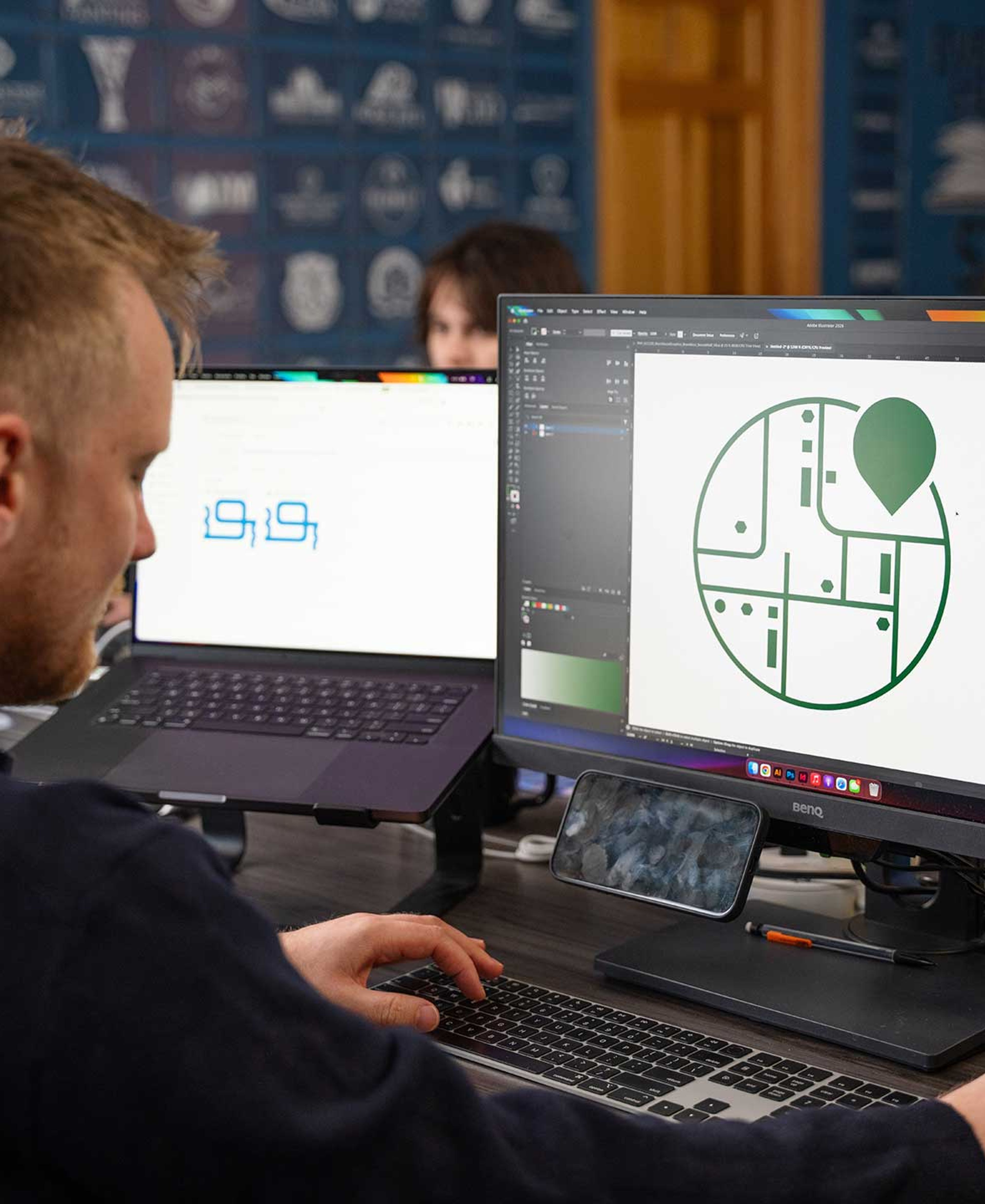 Graphic designer working in Adobe on his computer