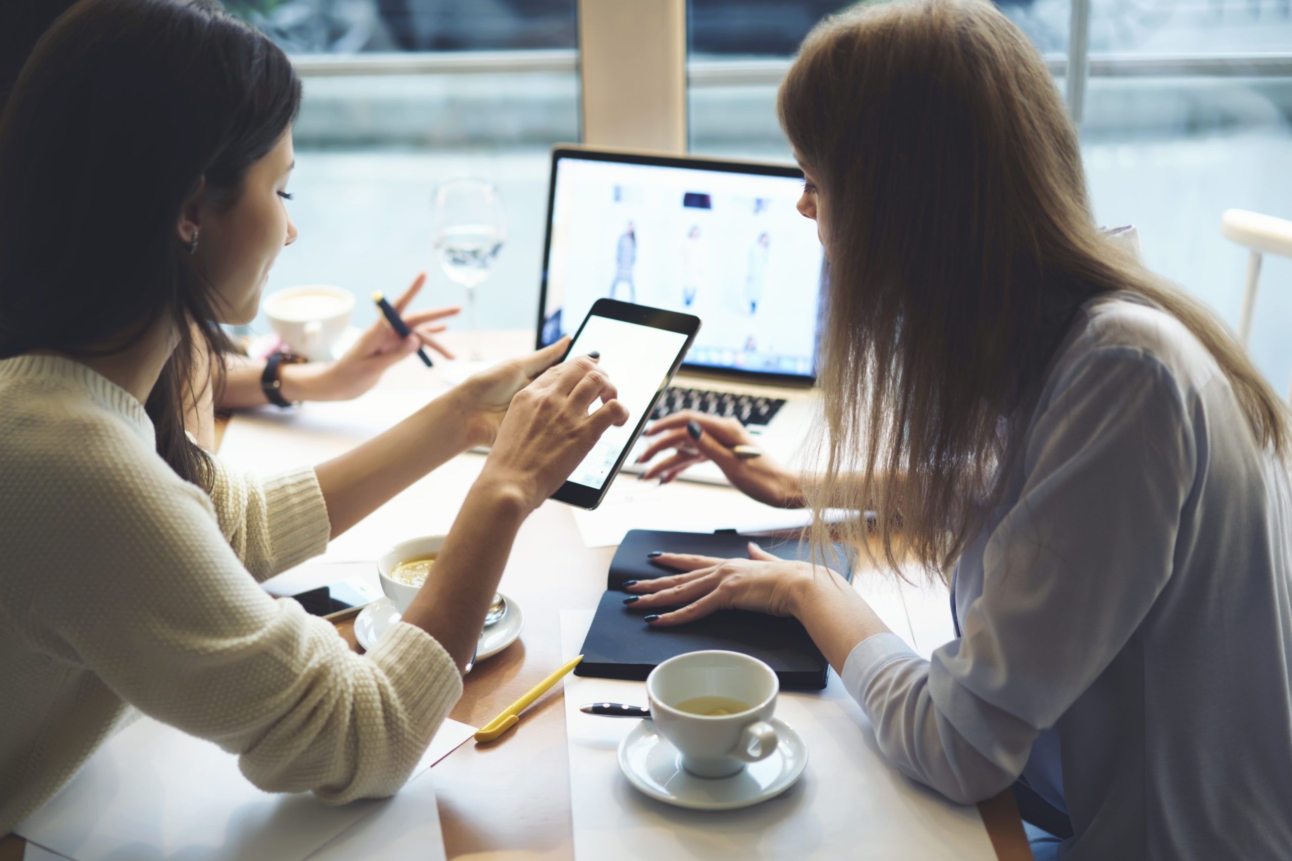 Two women working on computer
