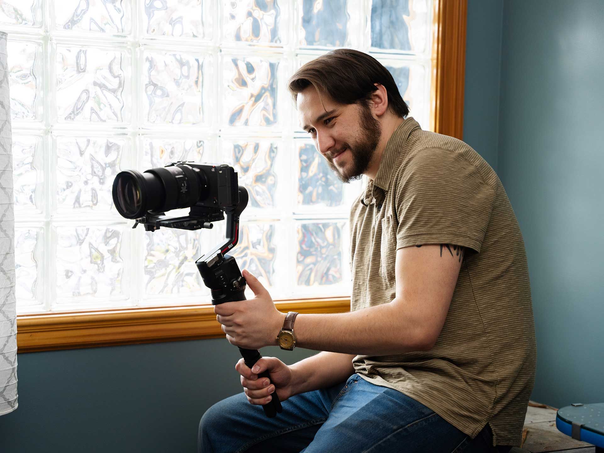 898 Marketing videographer holding a Sony camera on a gimbal stabilizer