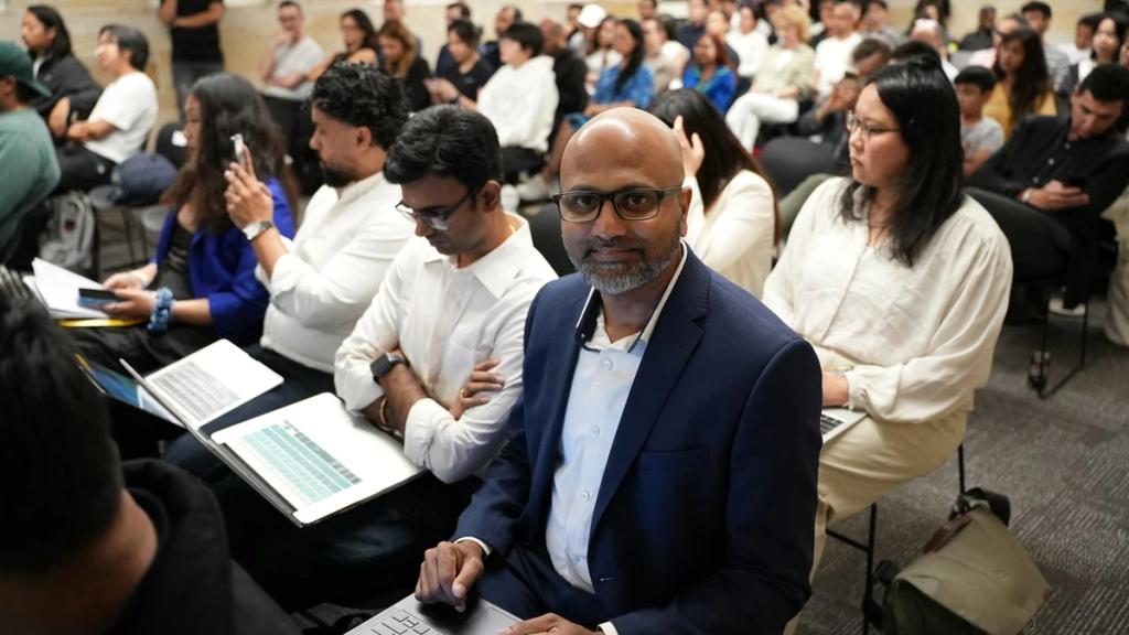 The audience follows a session, laptops open