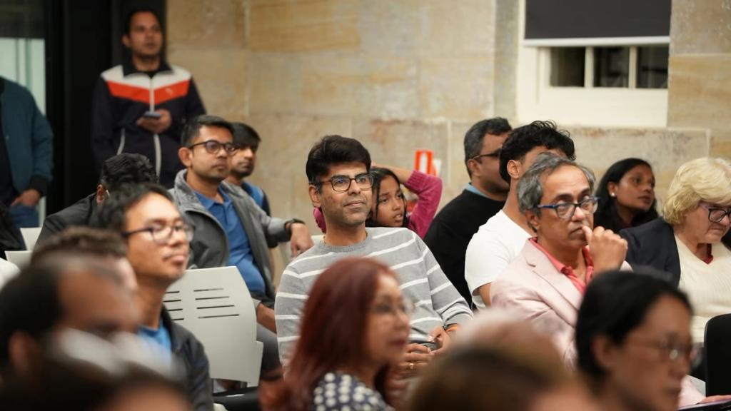 Attendees in the front row during a session.
