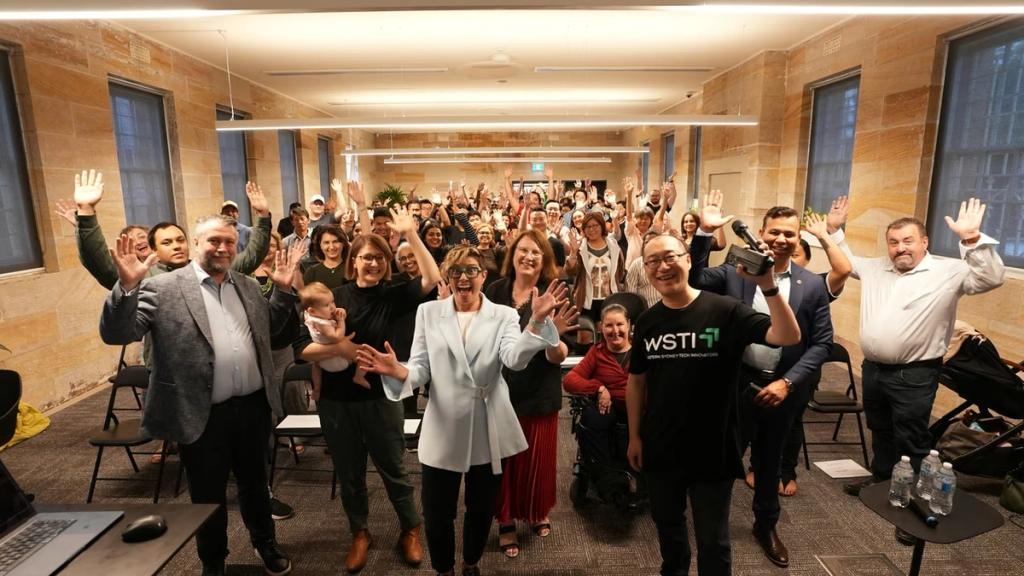 The full room at the Western Sydney AI Innovation Summit, arms in the air