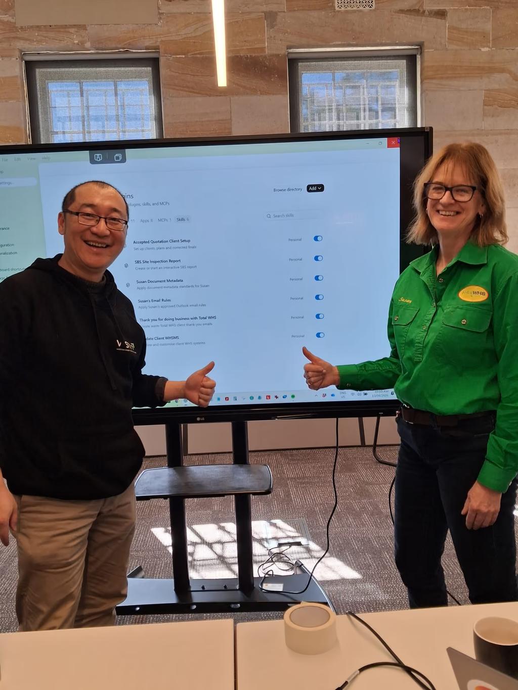 Susan Bennett beside Lailei Huang at the screen, her site inspection report automation listed behind them.