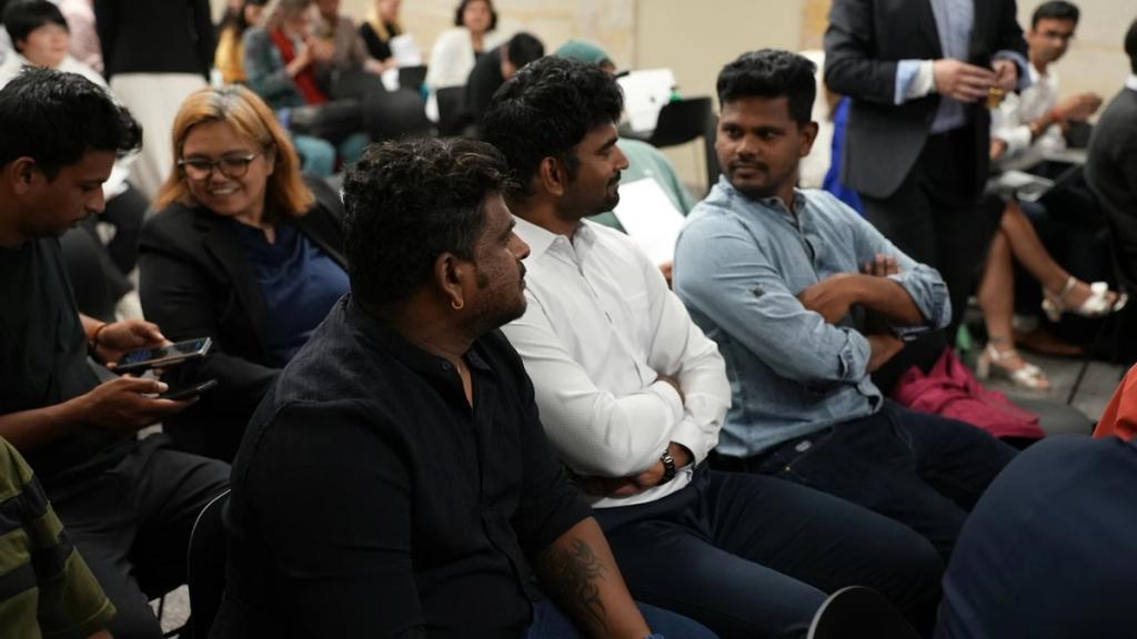 The audience listening from the floor