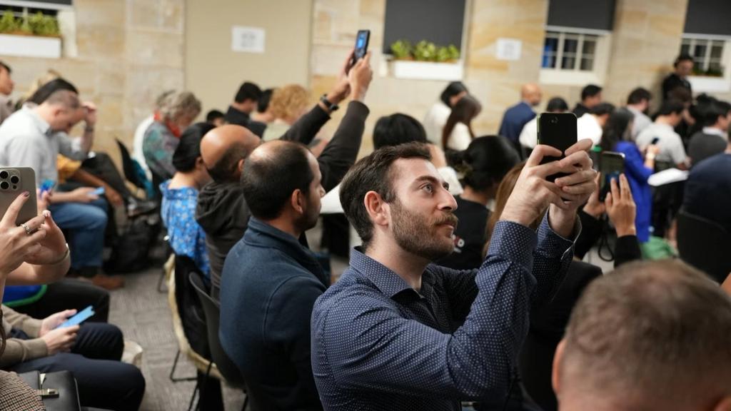 A packed audience follows a pitch from the floor