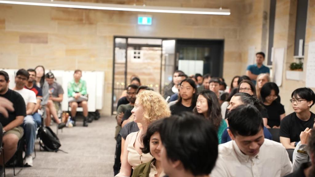 Rows of attendees seated for a talk.