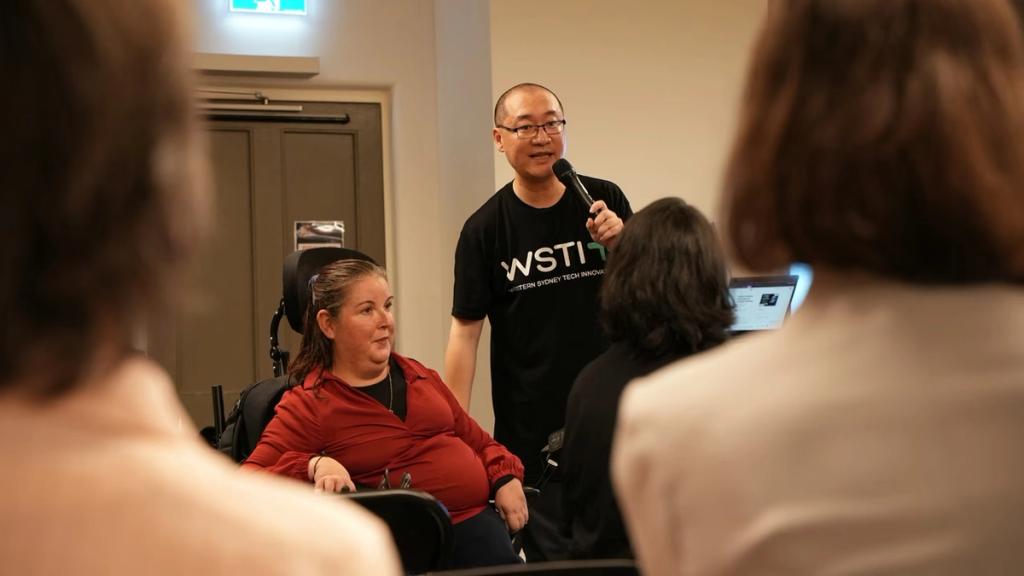 A WSTI member chats with attendees between talks