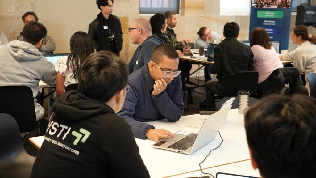 One of the team helping a participant at their laptop.