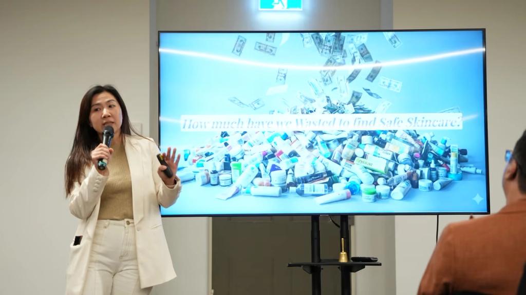 A speaker presenting a product slide to the room.