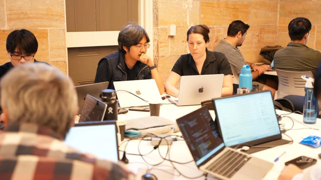Participants building across the open workspace.