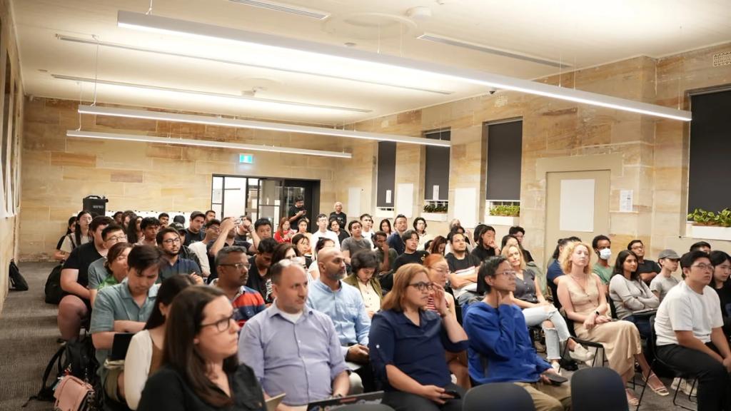 A full room of attendees seated for a session.