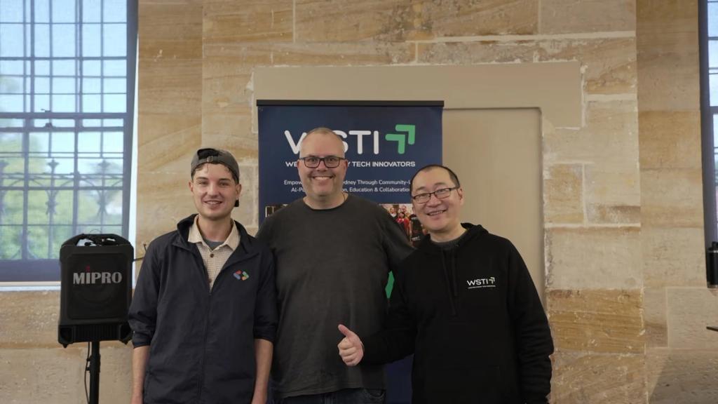 At the WSTI banner during the From Design to Ship: Build with AI × Google one-day hackathon