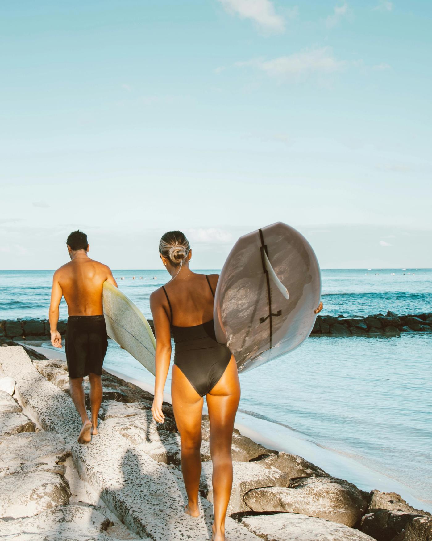 Adventurous Couple paddle boarding on vacation 