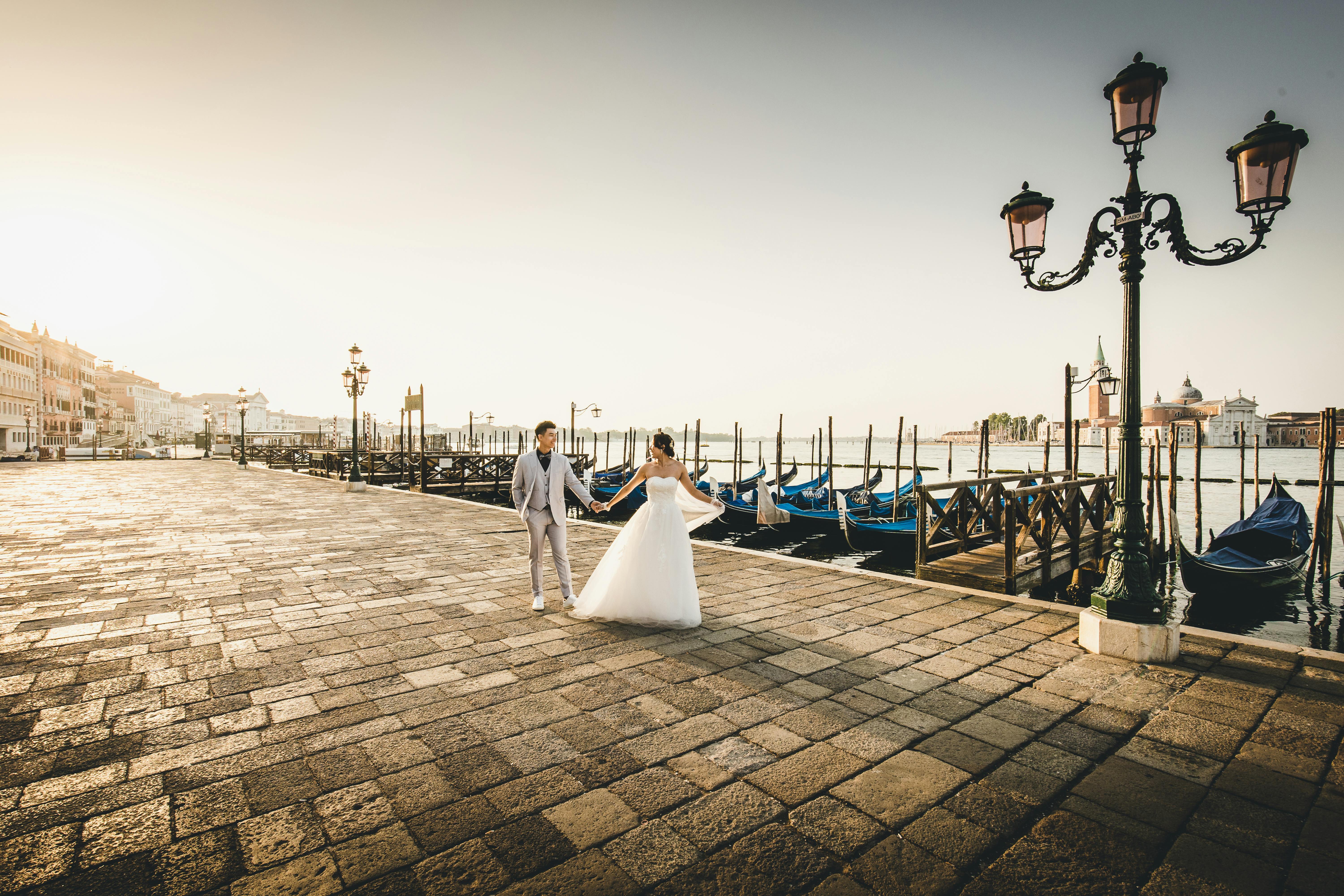 Married couple walking together on a dreamy boulevard after their destination wedding