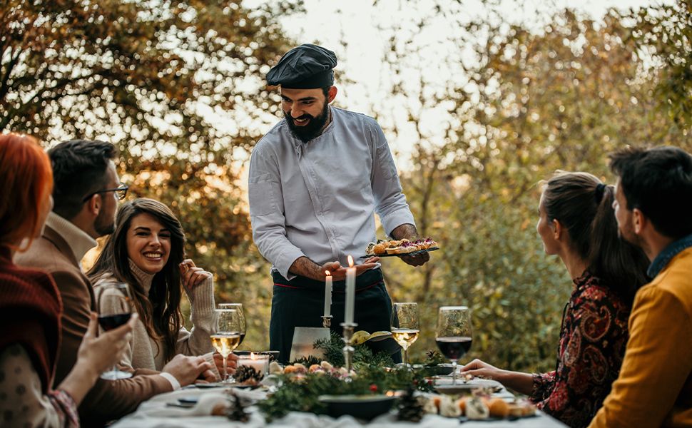 Private chef serving food outside
