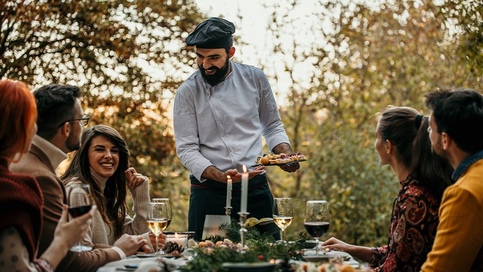 Private chef serving food outside