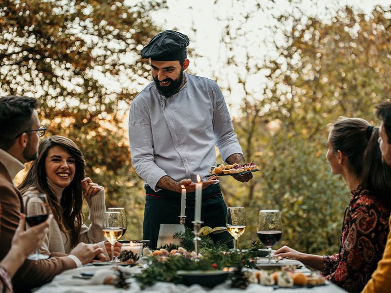 Private chef serving food outside